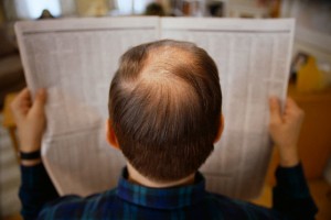Balding Man Reading Newspaper