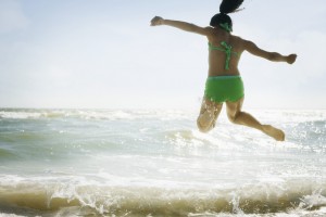 Girl Jumping in Waves